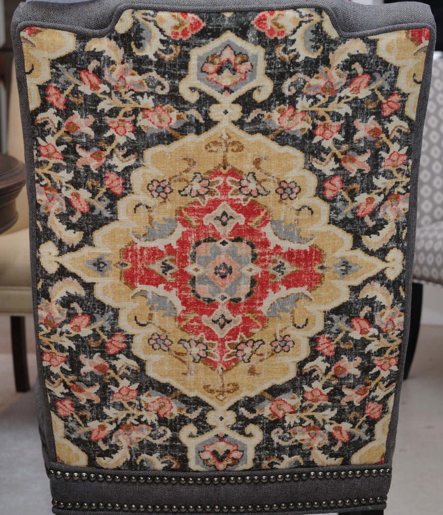 Coral punches up this traditional fabric pattern on a Sam Moore dining chair