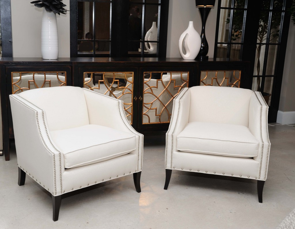 The Rory chairs sparkle with silver linen threads beside the metallic mirrored Sanctuary chest