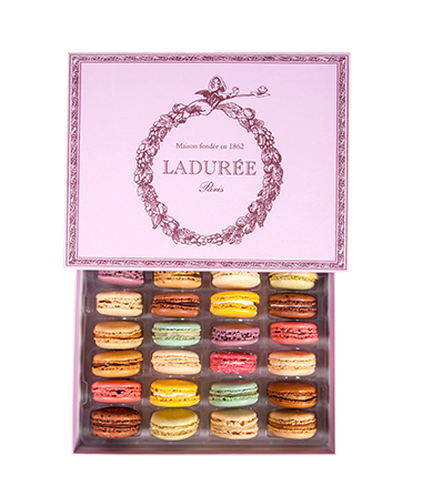 Create a sophisticated edible centerpiece by filling a tiered server with colorful Laduree macarons. Credit: Laduree.com